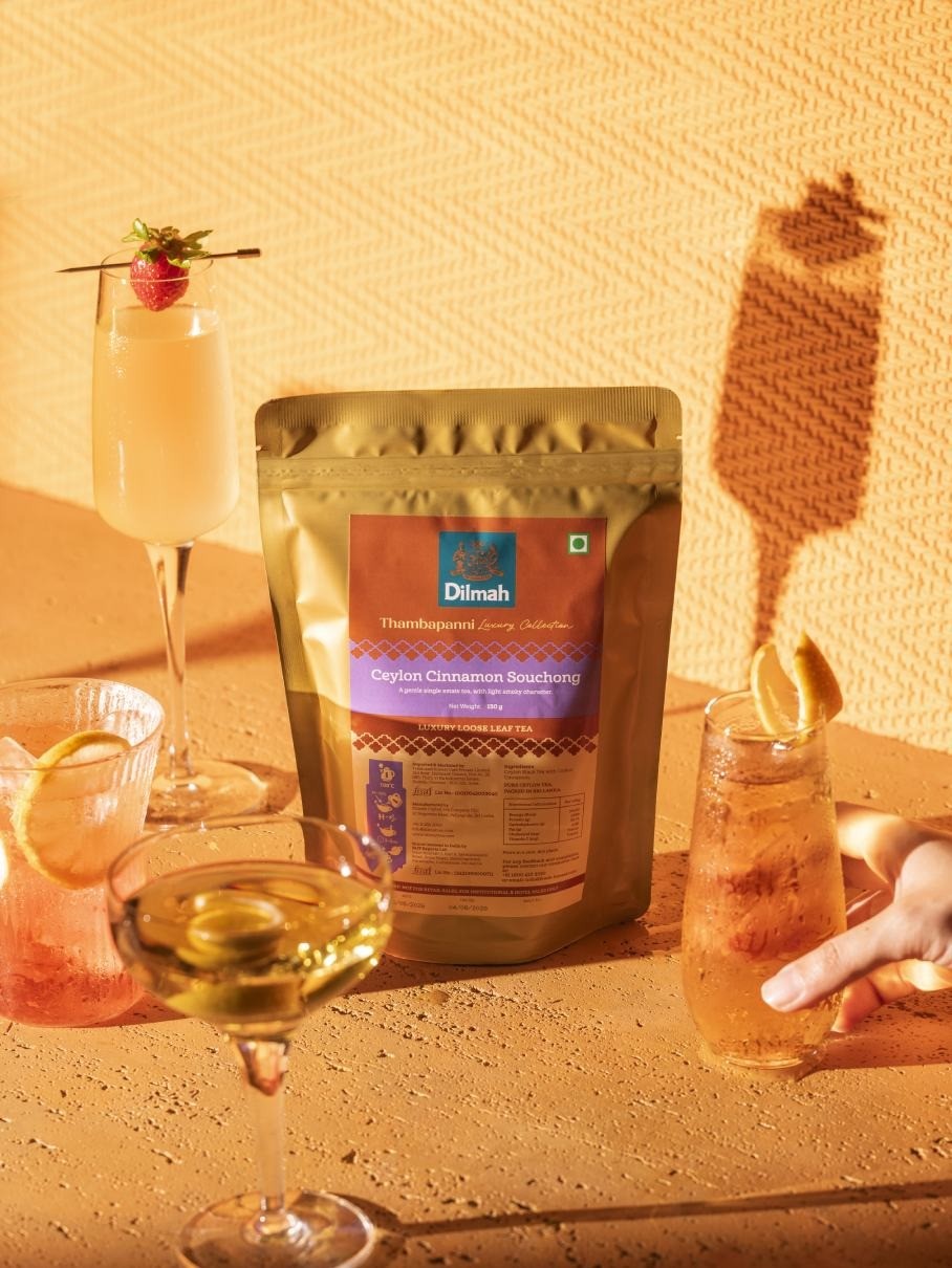A Ceylon tea-based cocktail garnished with herbs and citrus